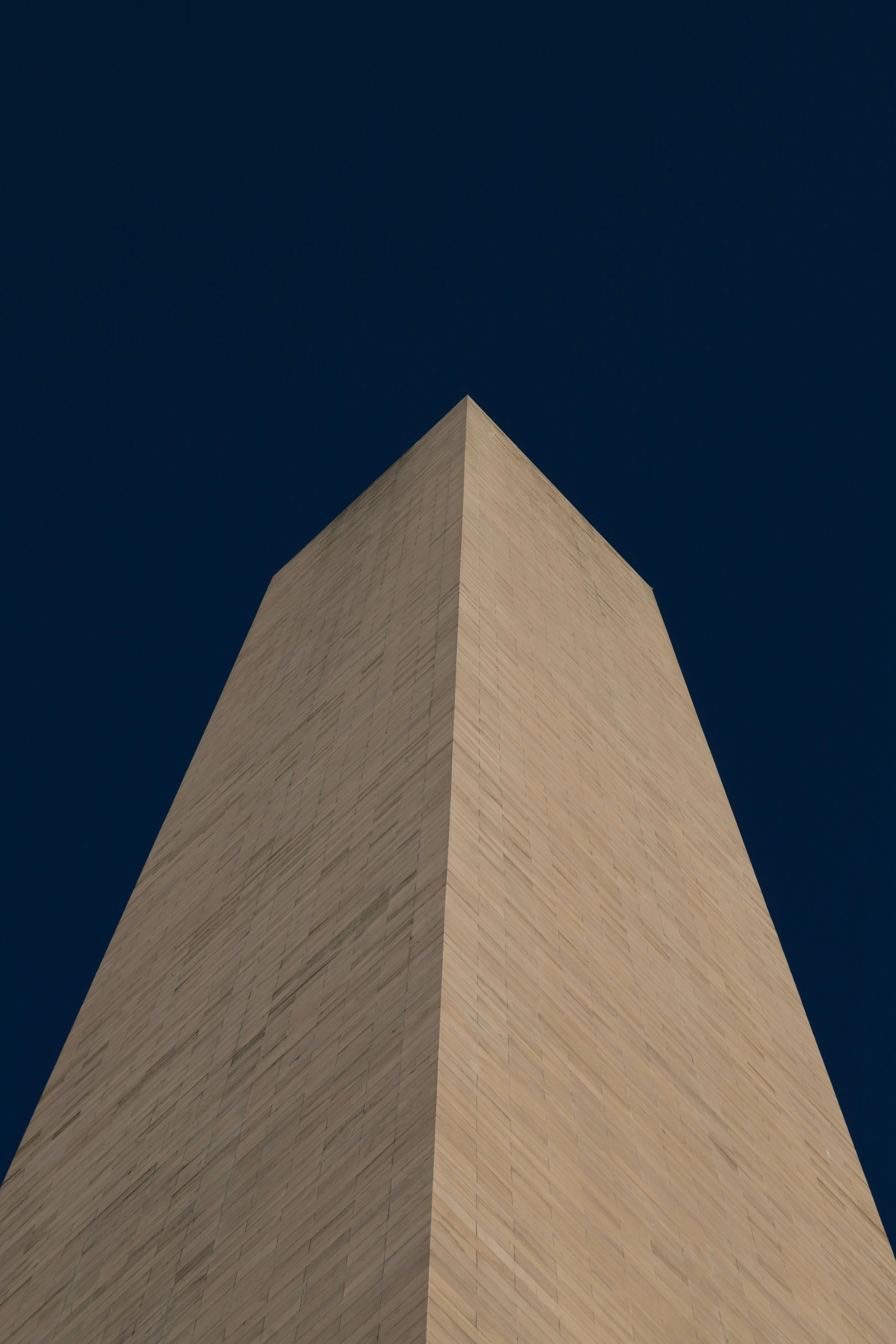 the top of a tall building with a blue sky in the background
