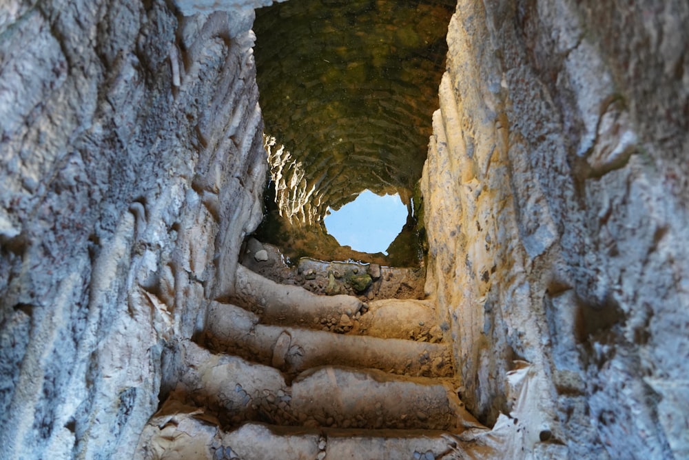 there is a stone staircase going up to a cave