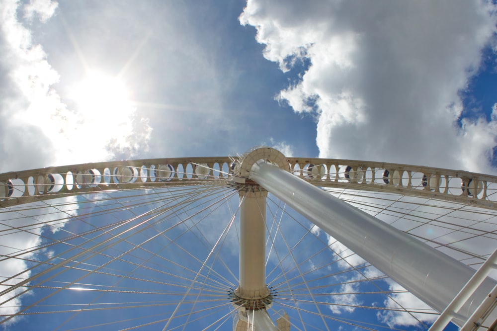 a large ferris wheel under a cloudy blue sky