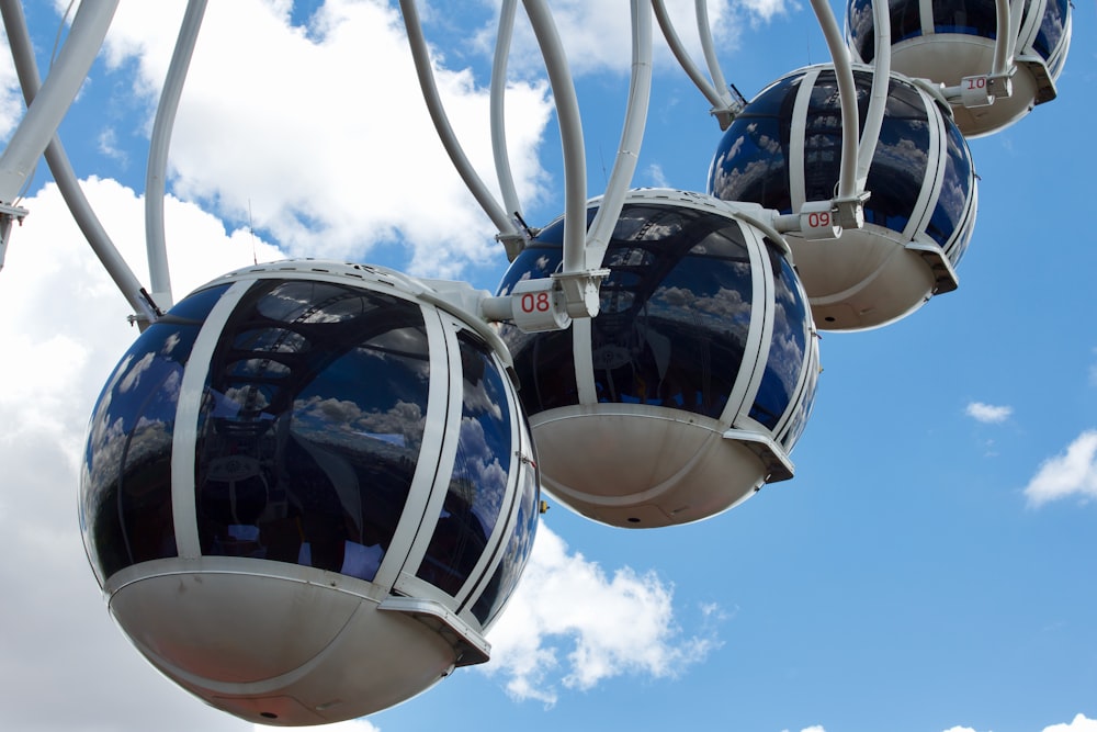 a group of blue and white gondolas hanging in the air