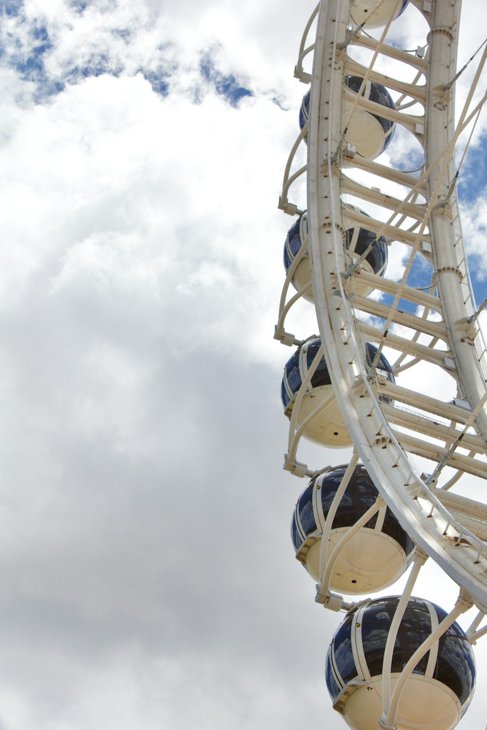 a ferris wheel is shown against a cloudy sky