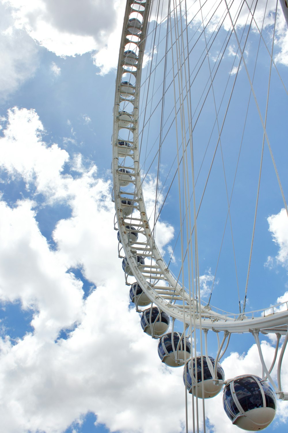 a ferris wheel is shown against a cloudy blue sky