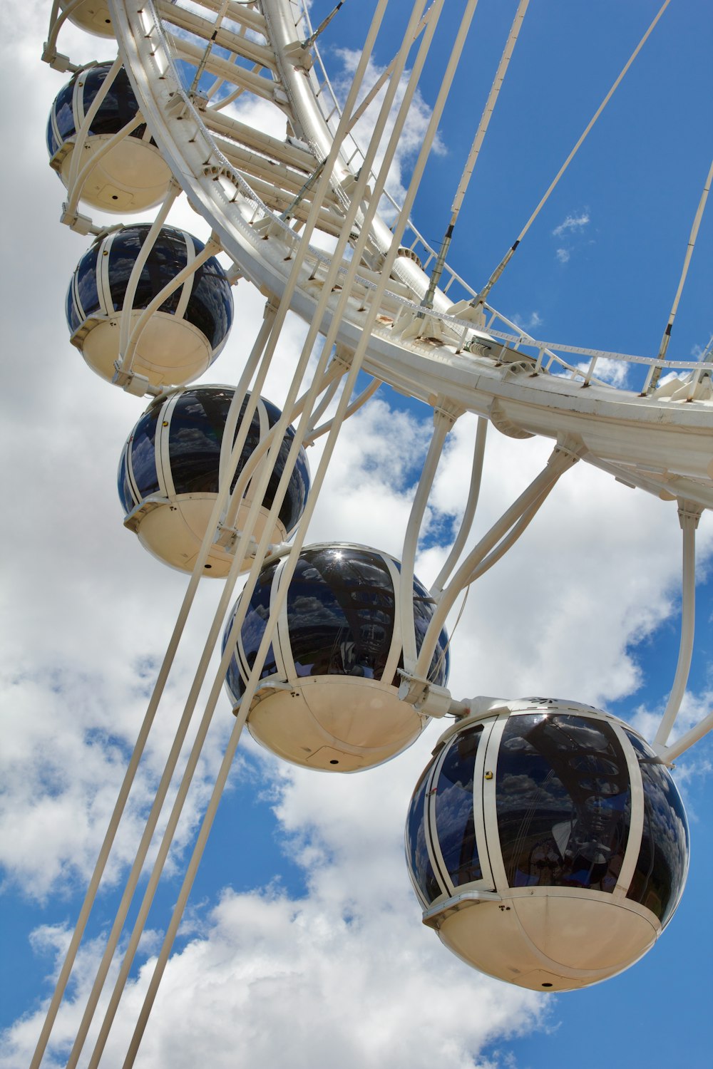 a ferris wheel with blue and white balls hanging from it