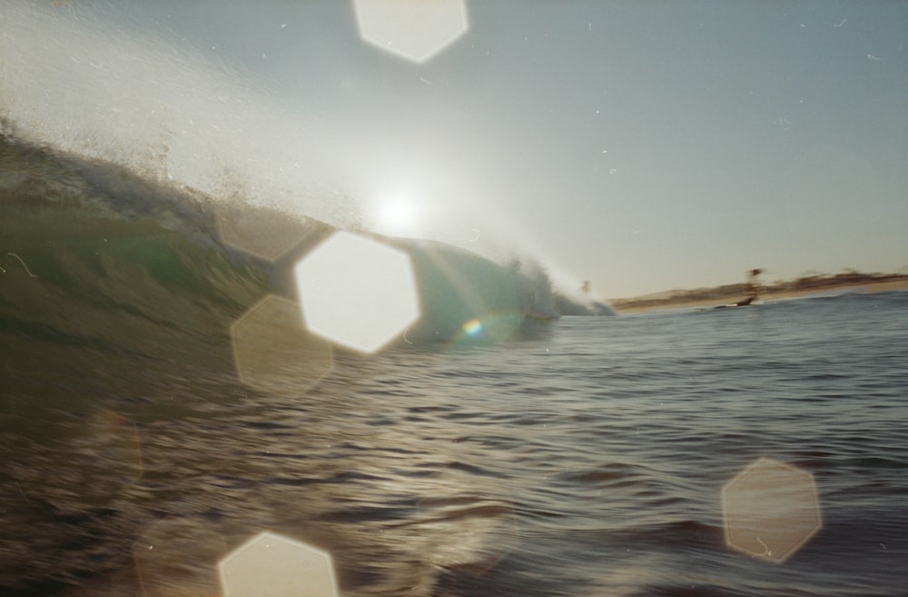 a man riding a wave on top of a surfboard