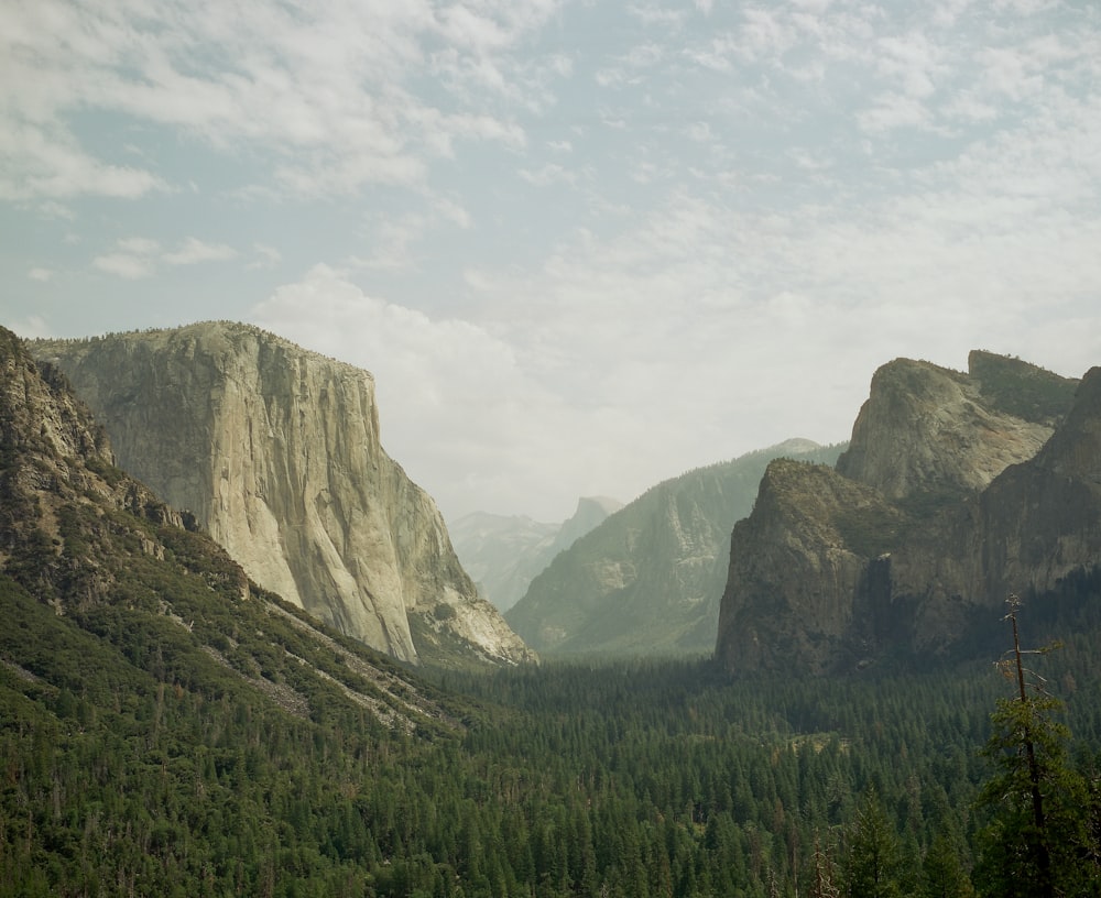 a view of a valley with mountains in the background