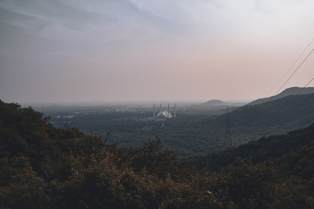 a view of a valley with a church in the distance