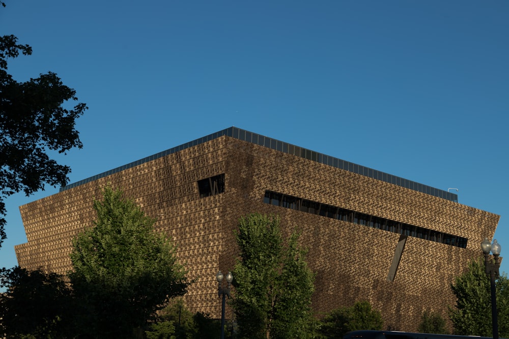 a large building with a lot of windows and trees in front of it