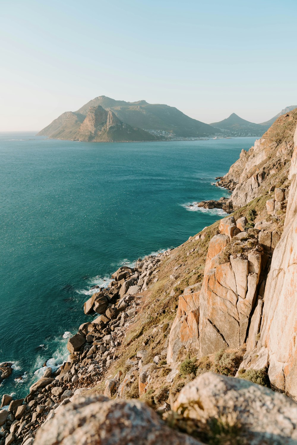 a person standing on a cliff overlooking the ocean