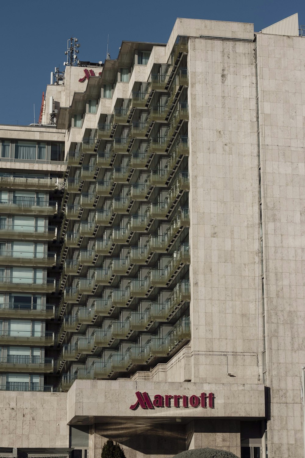 a tall building with balconies on top of it