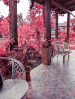An artistic view of a tiled patio with garden furniture.