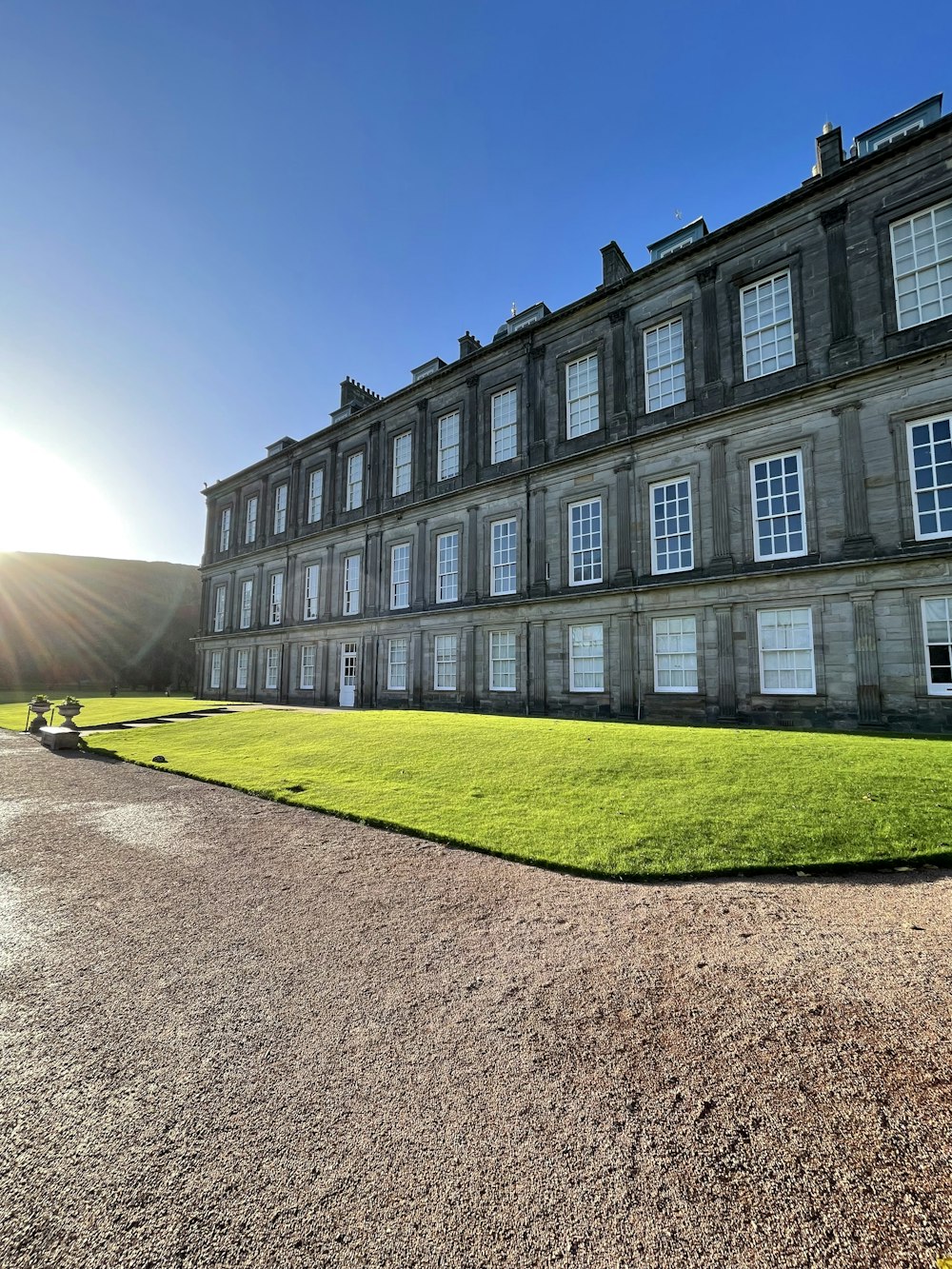 a large building with a lawn in front of it