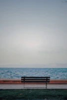 A quiet moment of reflection with the runninrev seated on a bench overlooking a calm river.
