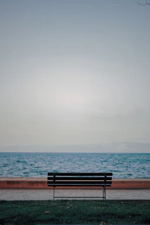 A quiet moment of reflection with the runninrev seated on a bench overlooking a calm river.