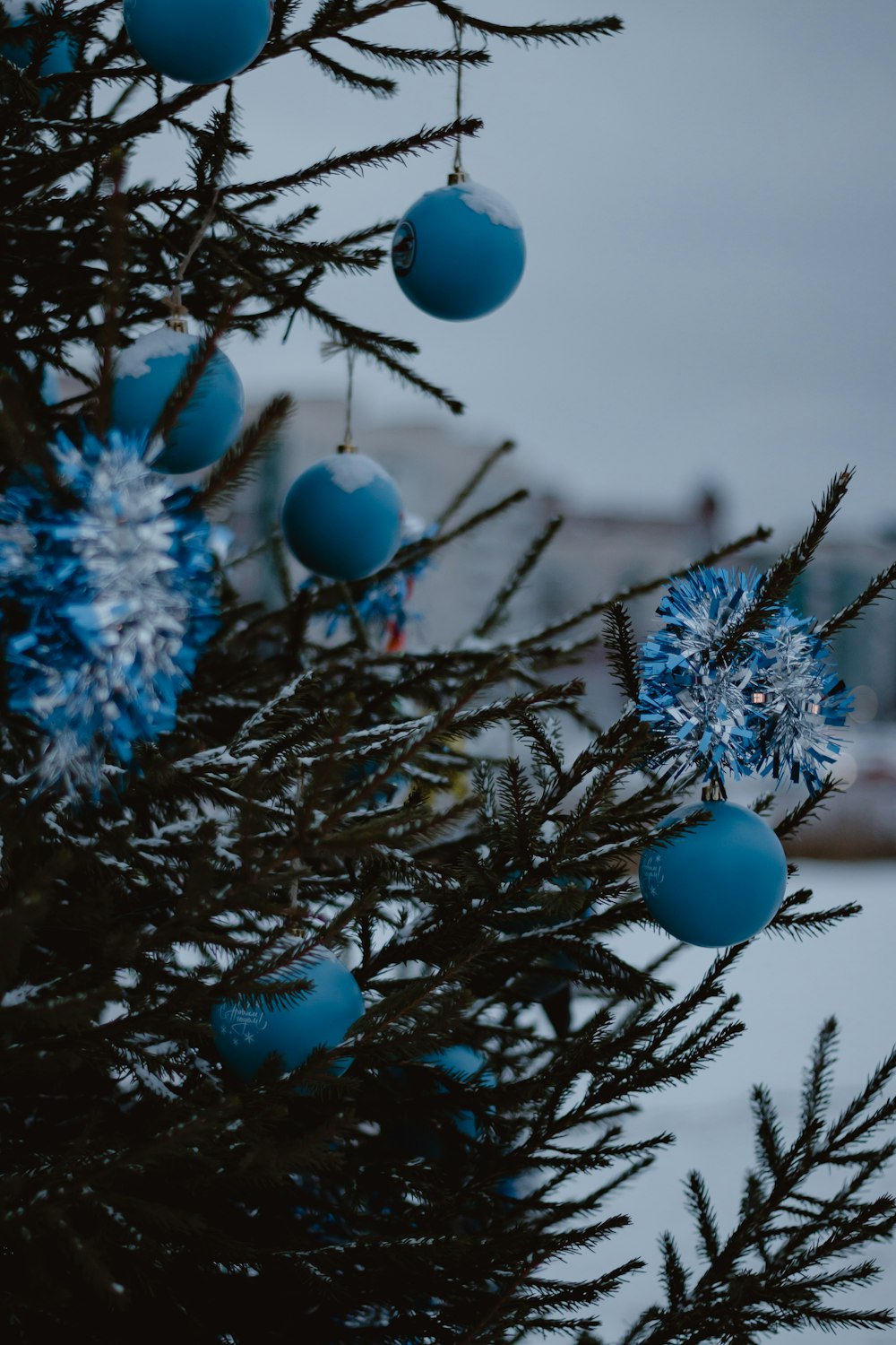 a close up of a christmas tree with blue ornaments