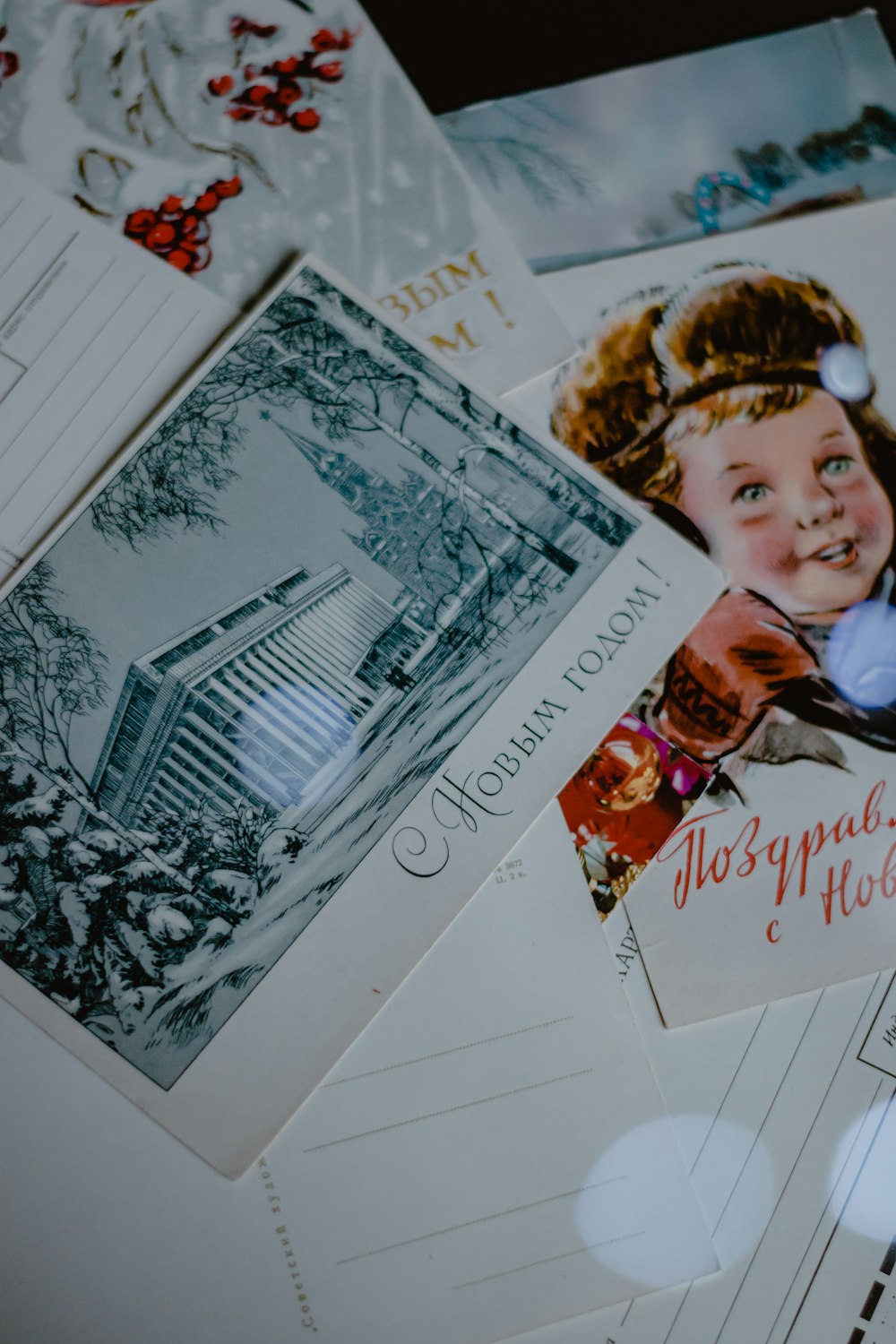 a pile of postcards with a picture of a child on them