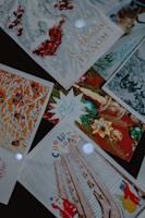 A collection of festive greeting cards with Russian text. The cards feature winter and holiday-themed imagery such as red berries, decorated trees, architectural elements, and holiday ornaments. Some cards show illustrations of a Santa Claus figure.