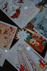A collection of festive greeting cards with Russian text. The cards feature winter and holiday-themed imagery such as red berries, decorated trees, architectural elements, and holiday ornaments. Some cards show illustrations of a Santa Claus figure.