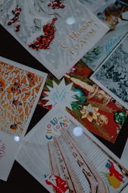 A collection of festive greeting cards with Russian text. The cards feature winter and holiday-themed imagery such as red berries, decorated trees, architectural elements, and holiday ornaments. Some cards show illustrations of a Santa Claus figure.