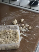 A cozy kitchen countertop with homemade frozen meal containers neatly stacked, ready for sale.
