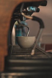 a coffee cup is sitting on a coffee machine