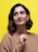 a woman in a brown sweater posing for a picture
