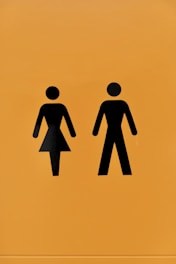 a yellow sign with a picture of a man and a woman