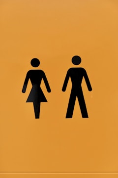 a yellow sign with a picture of a man and a woman