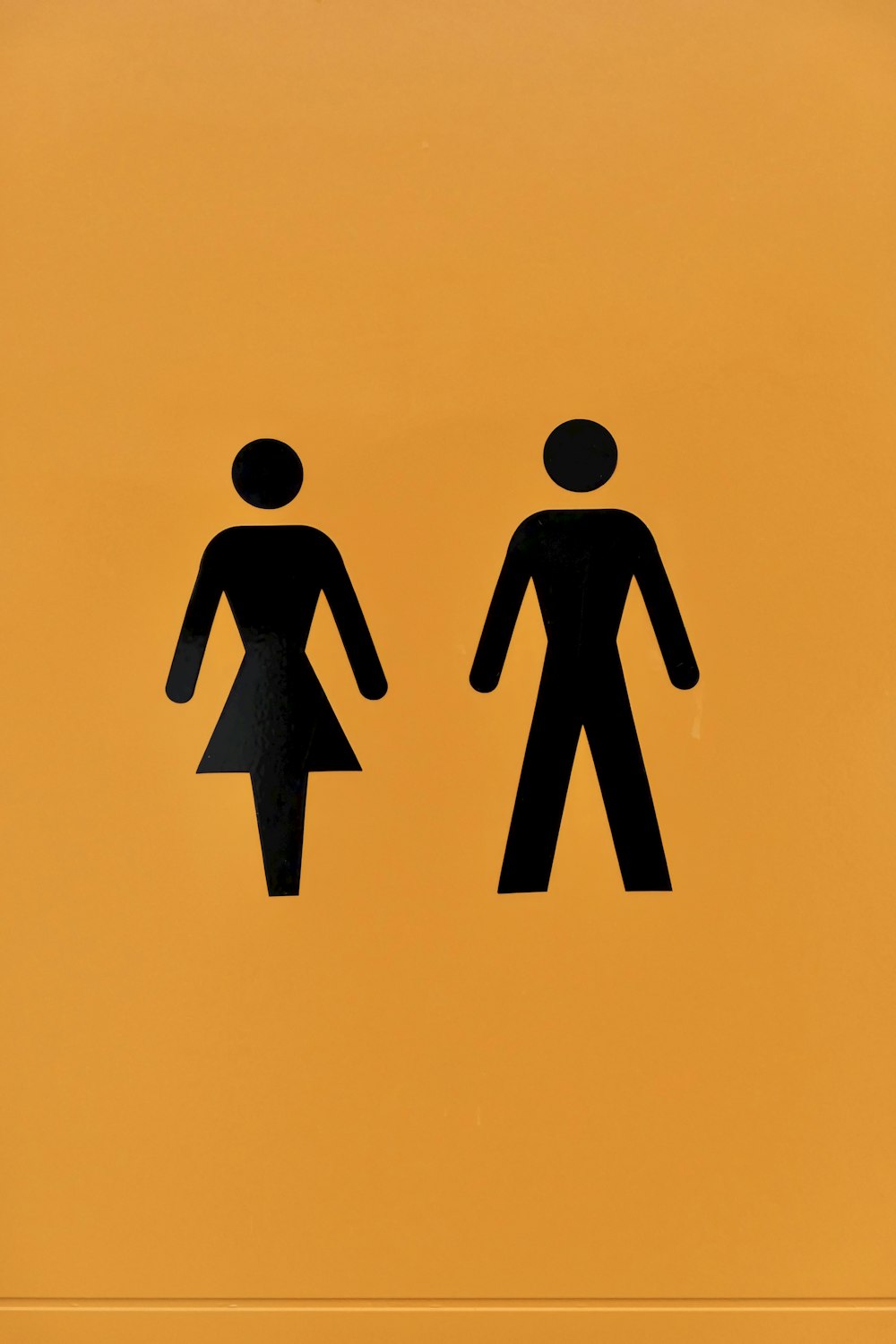 a yellow sign with a picture of a man and a woman