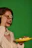 Close-up of a smiling woman holding a beautifully presented sweet sushi plate in a cozy kitchen
