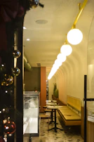 A modern cafe interior with glowing gold accents and elegant seating under soft lighting.