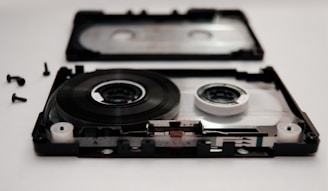 Close-up of a cassette player being carefully repaired.