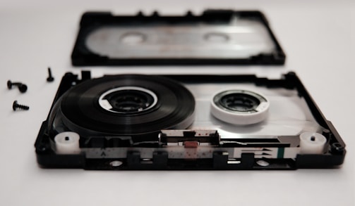 Close-up of a cassette player being carefully repaired.