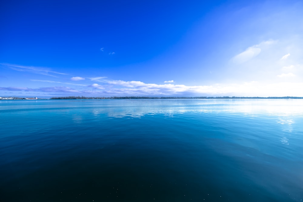 a body of water with a sky in the background