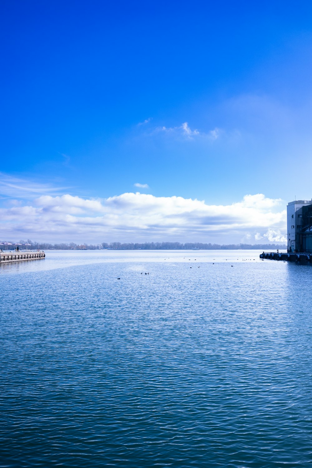 a large body of water with a building in the distance