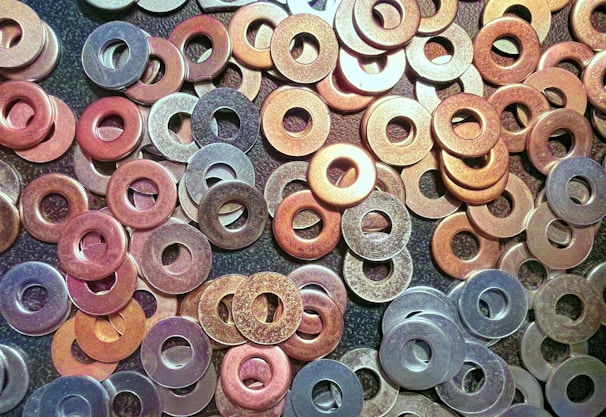 a pile of different colored washers sitting on top of a table