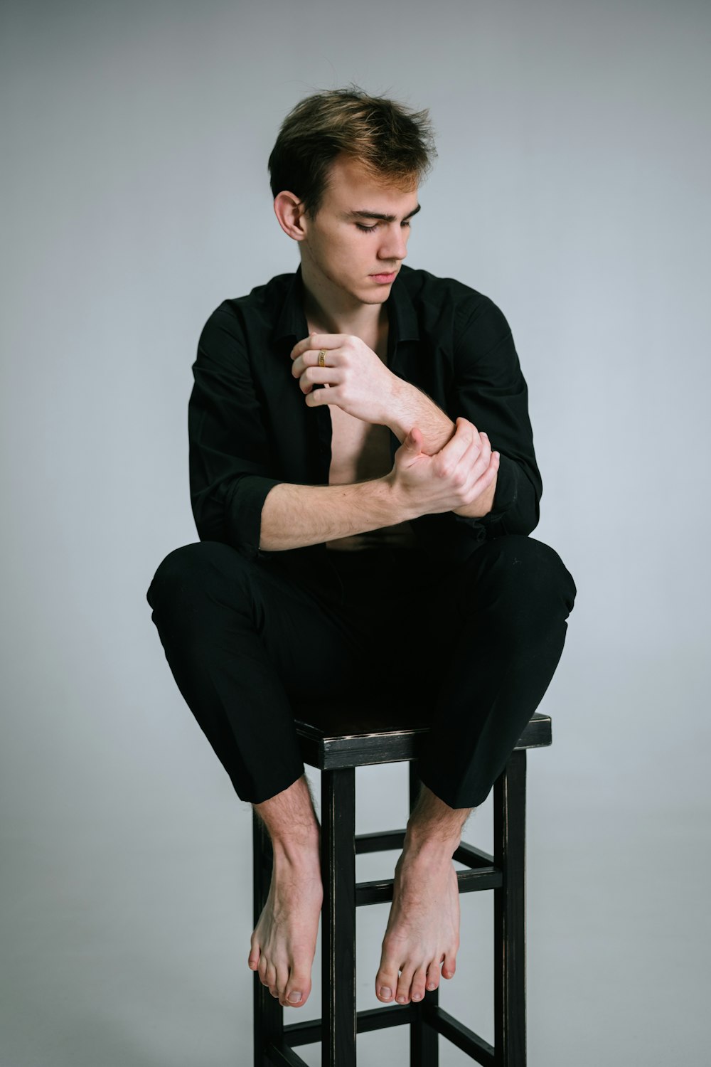 a man sitting on top of a stool