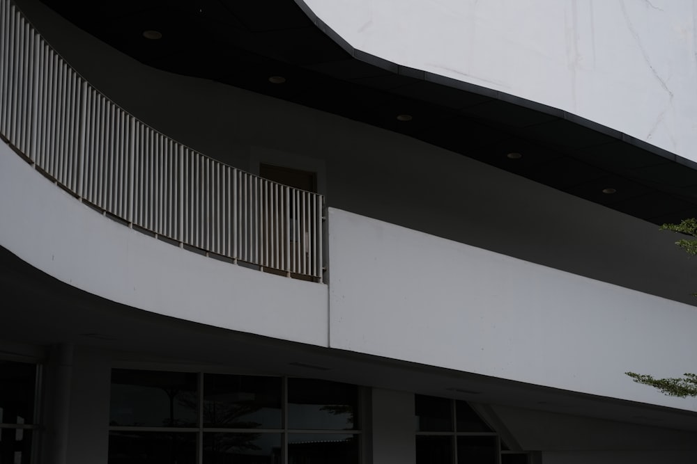 a white building with a balcony and balconies