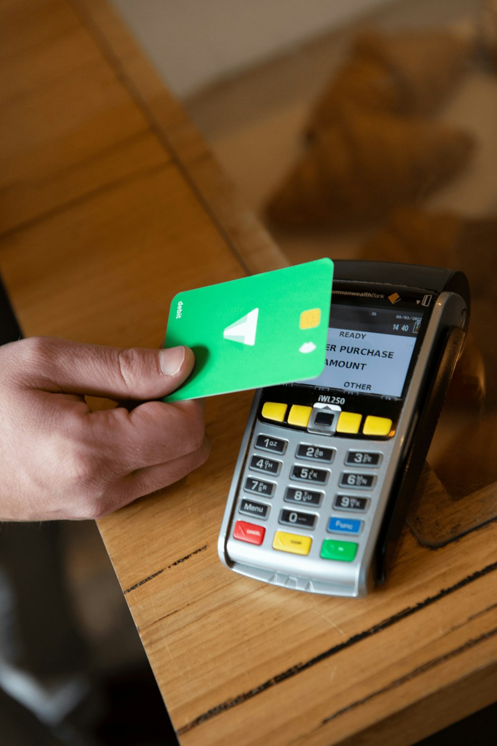 a person holding a credit card next to a calculator