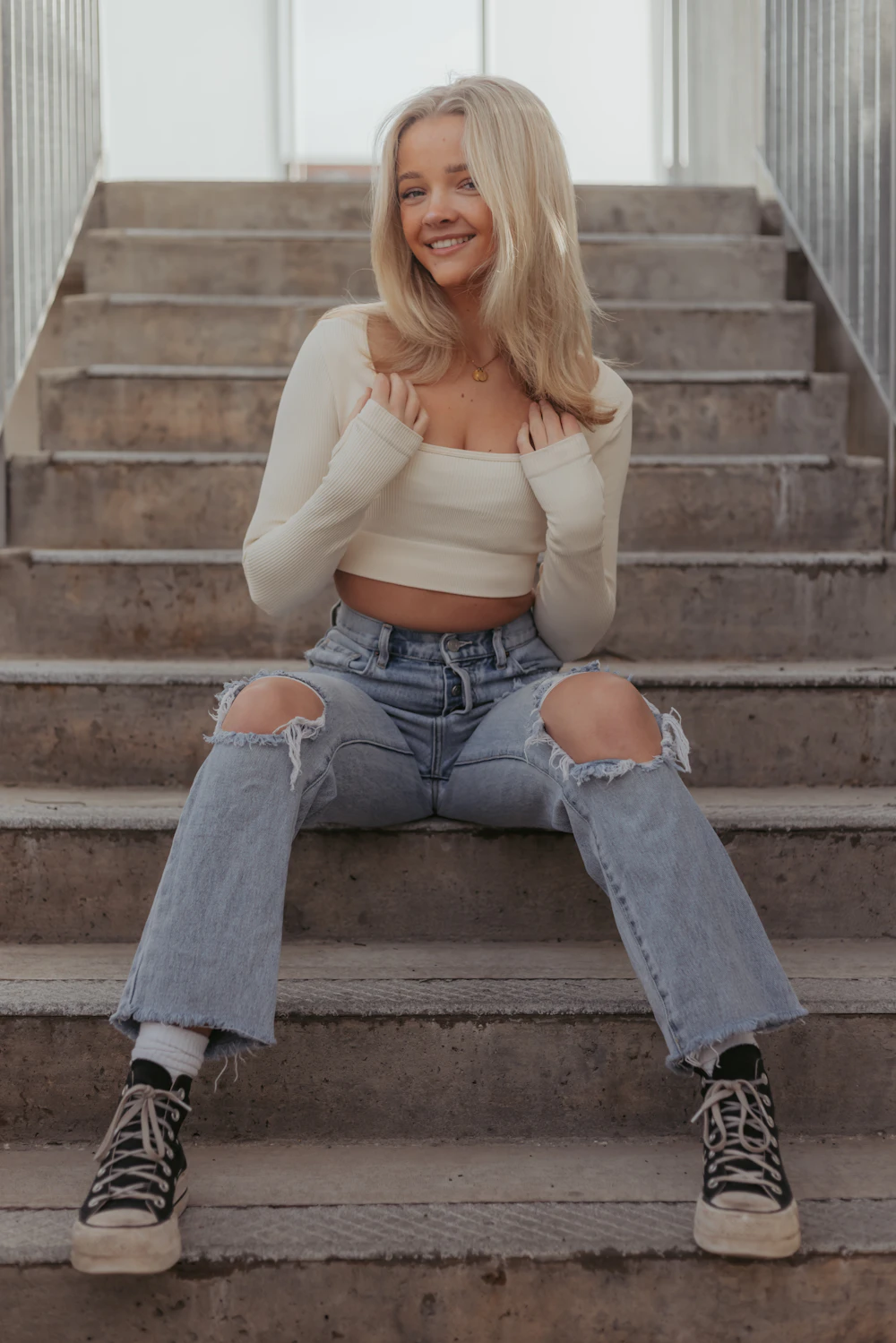 Cream ribbed long-sleeve crop top on stairs