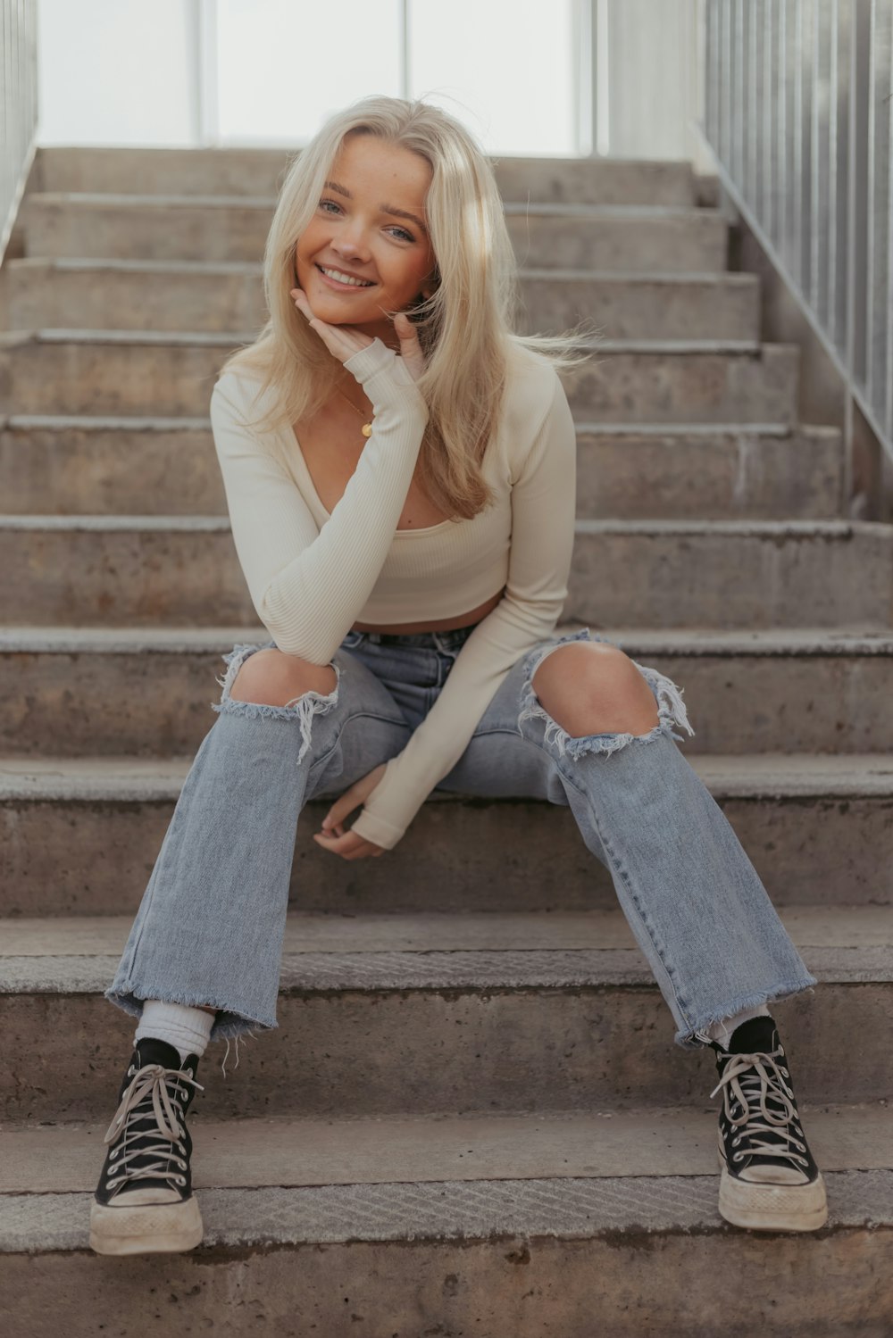 a woman sitting on the steps of a building