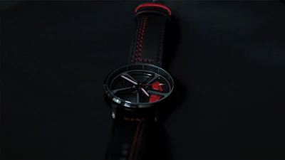 Minimalist black watch with a stainless steel band showcased against a dark textured background.