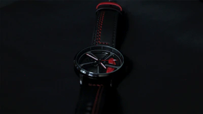 Sleek contemporary watch with a black metal band showcased against a dark background.