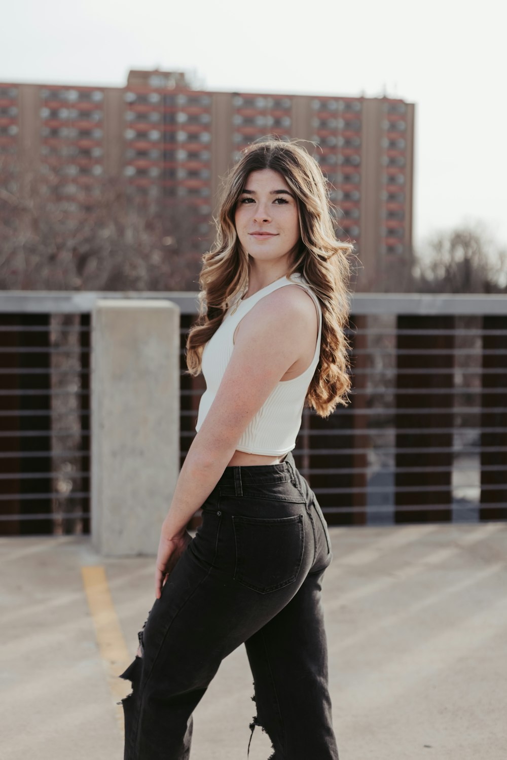 a woman in black pants and a white top