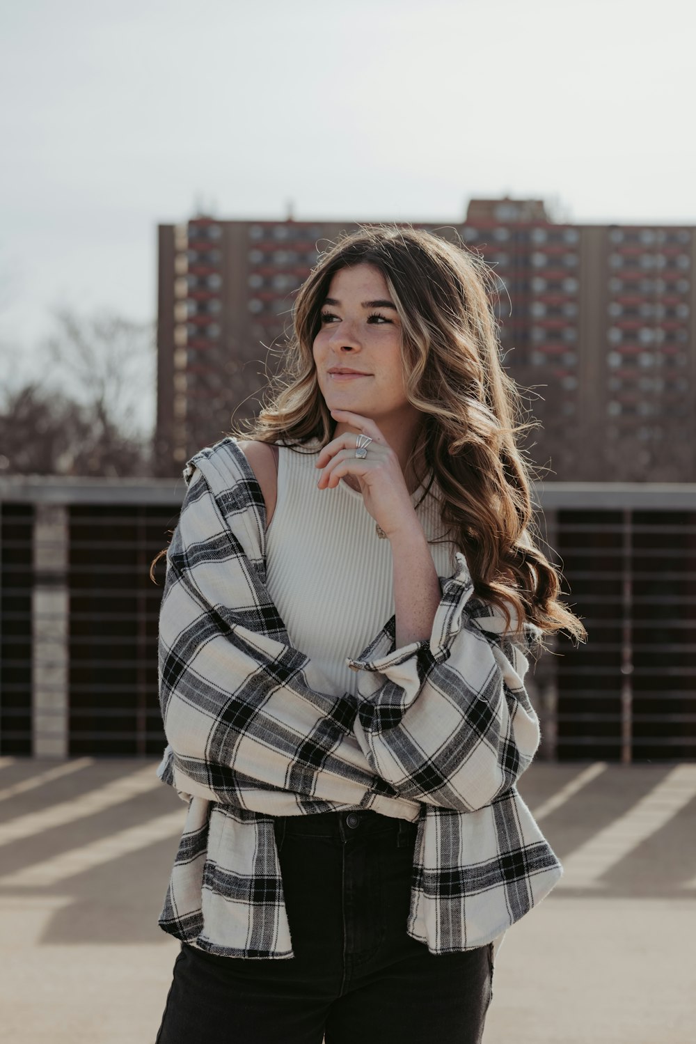 a woman wearing a plaid shirt and black jeans