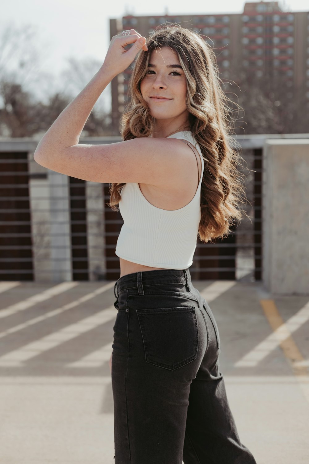 a woman in a white top and black pants