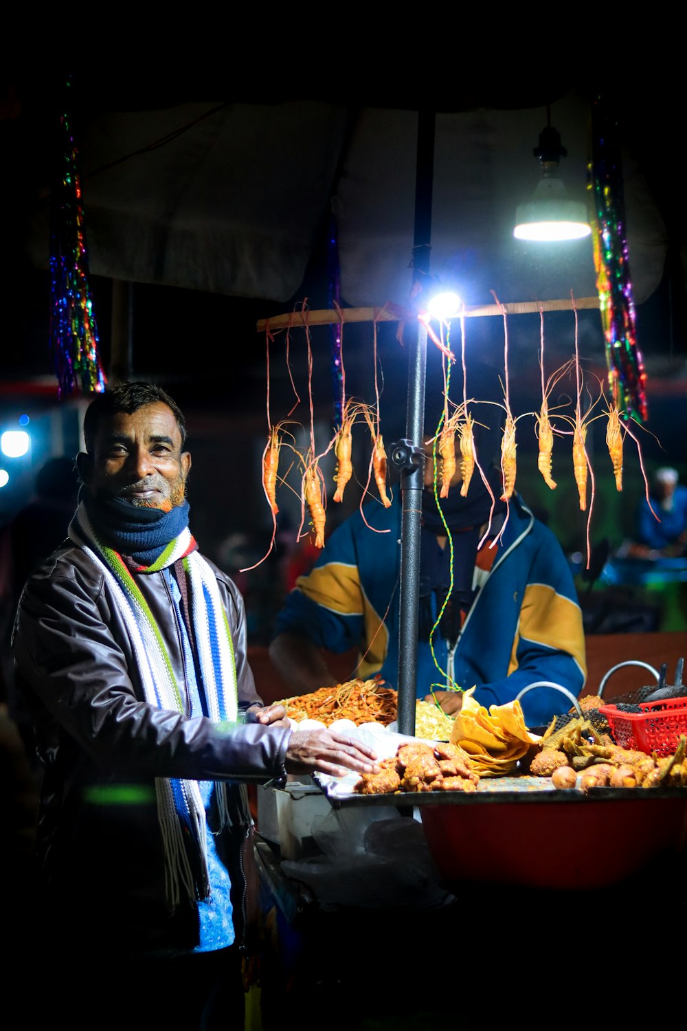 a man standing next to a table filled with food