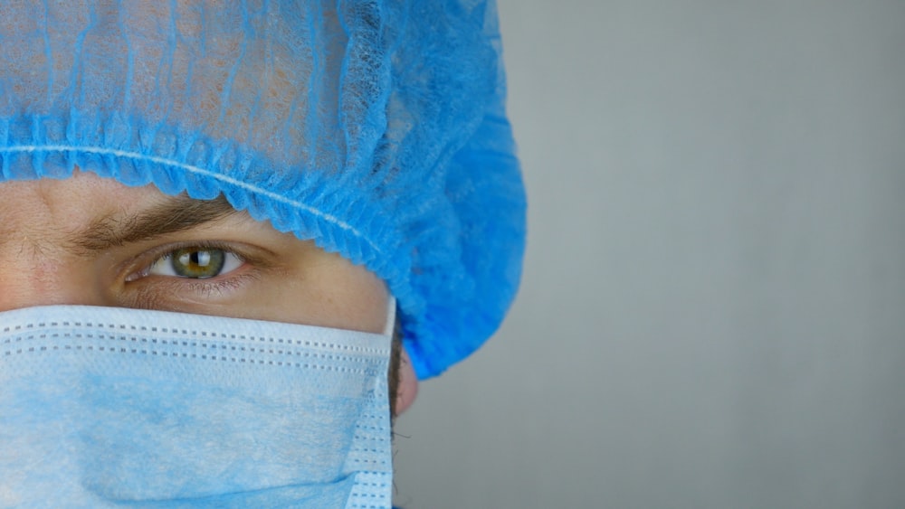 a close up of a person wearing a surgical mask