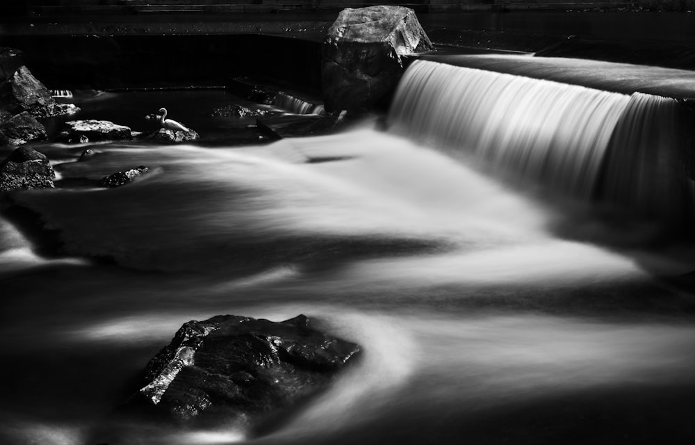 a black and white photo of a waterfall