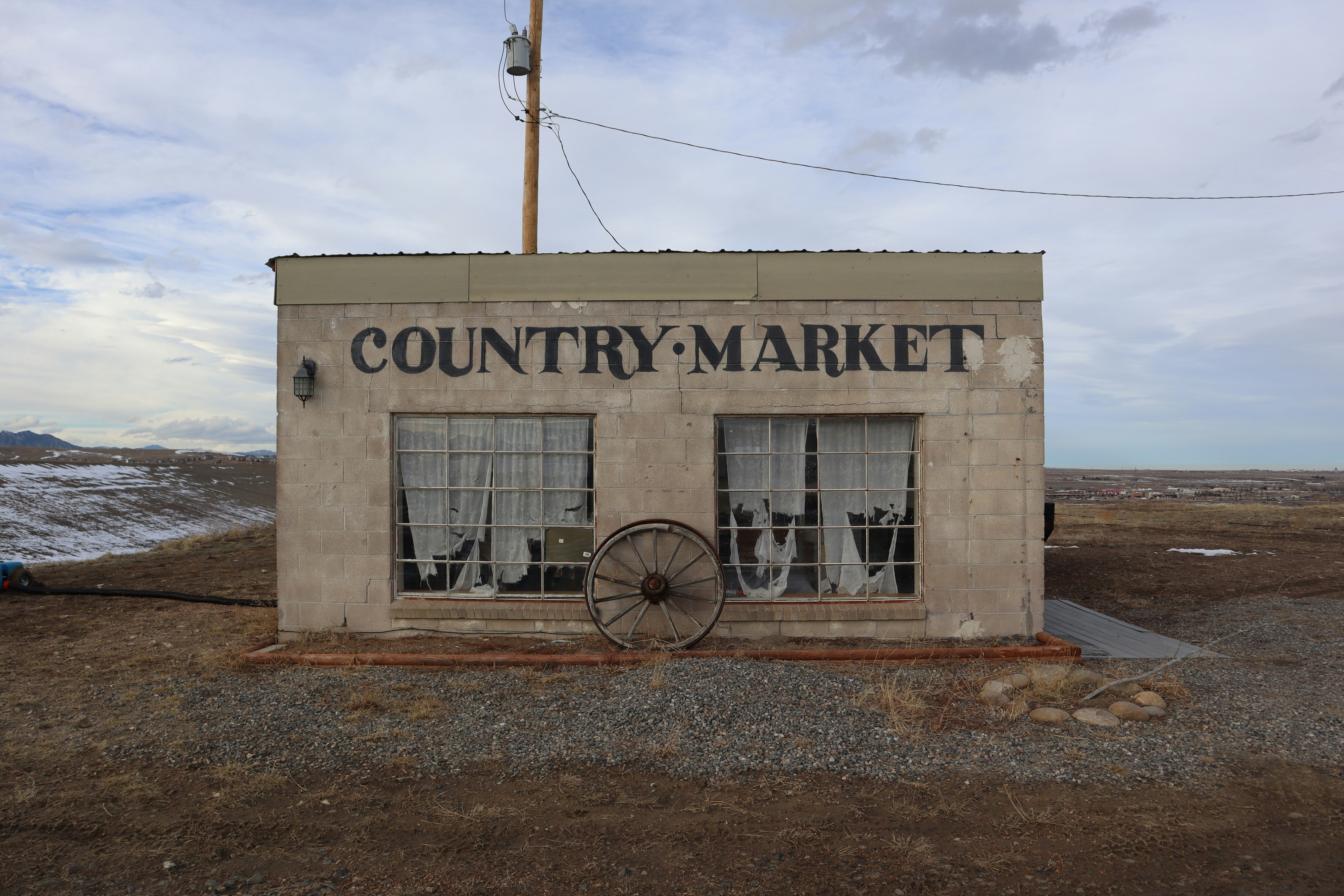 a small building with a wagon in front of it