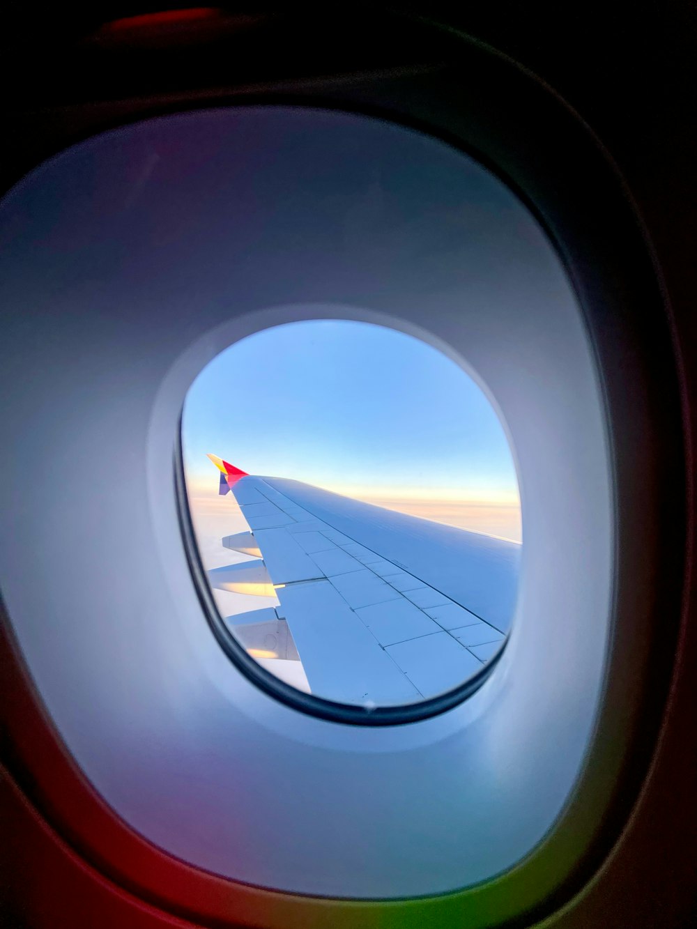 a view of the wing of an airplane through a window